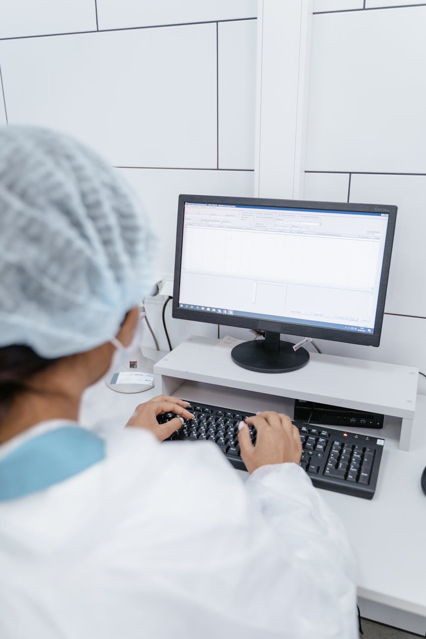 Medical professional analyzing data on a computer monitor in a laboratory setting