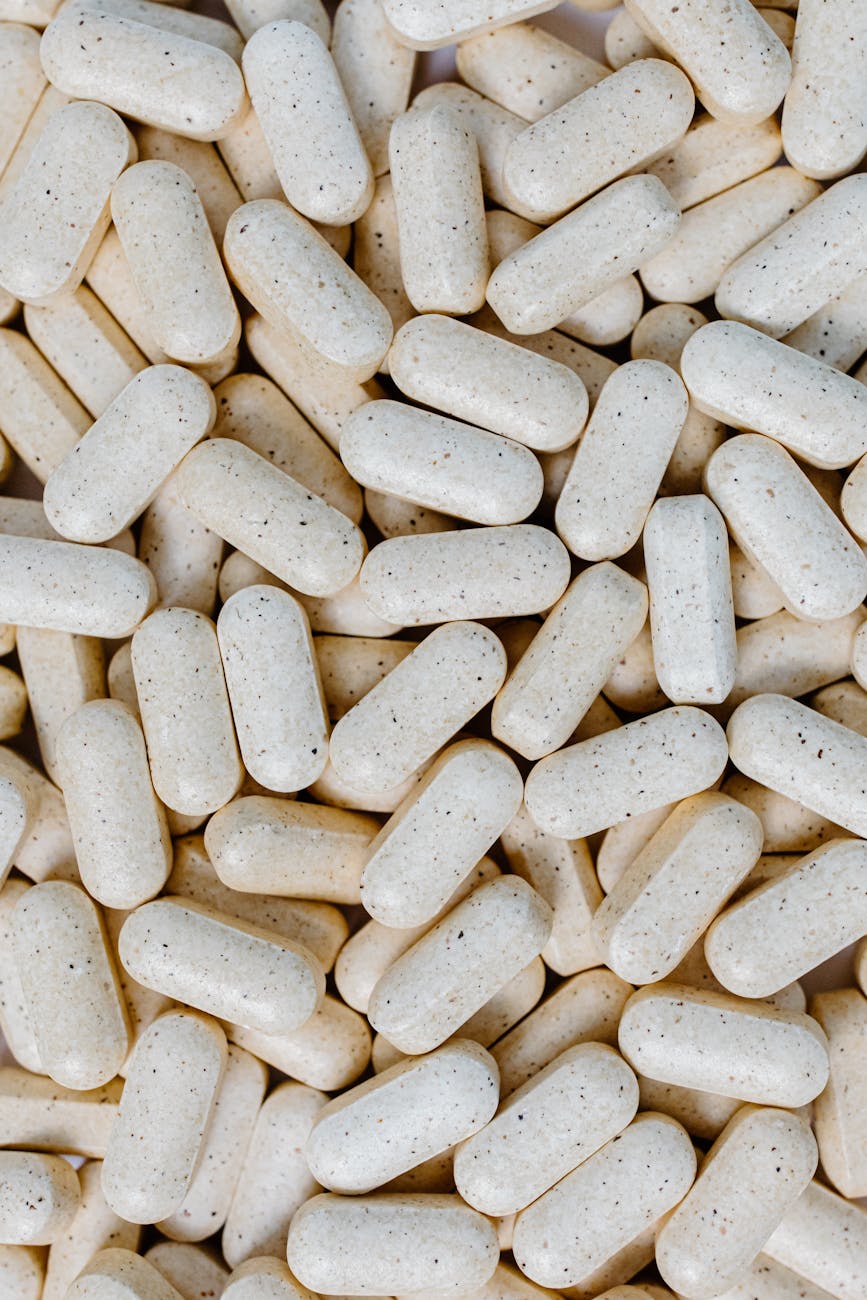 Close-up of white supplement tablets on a clean surface