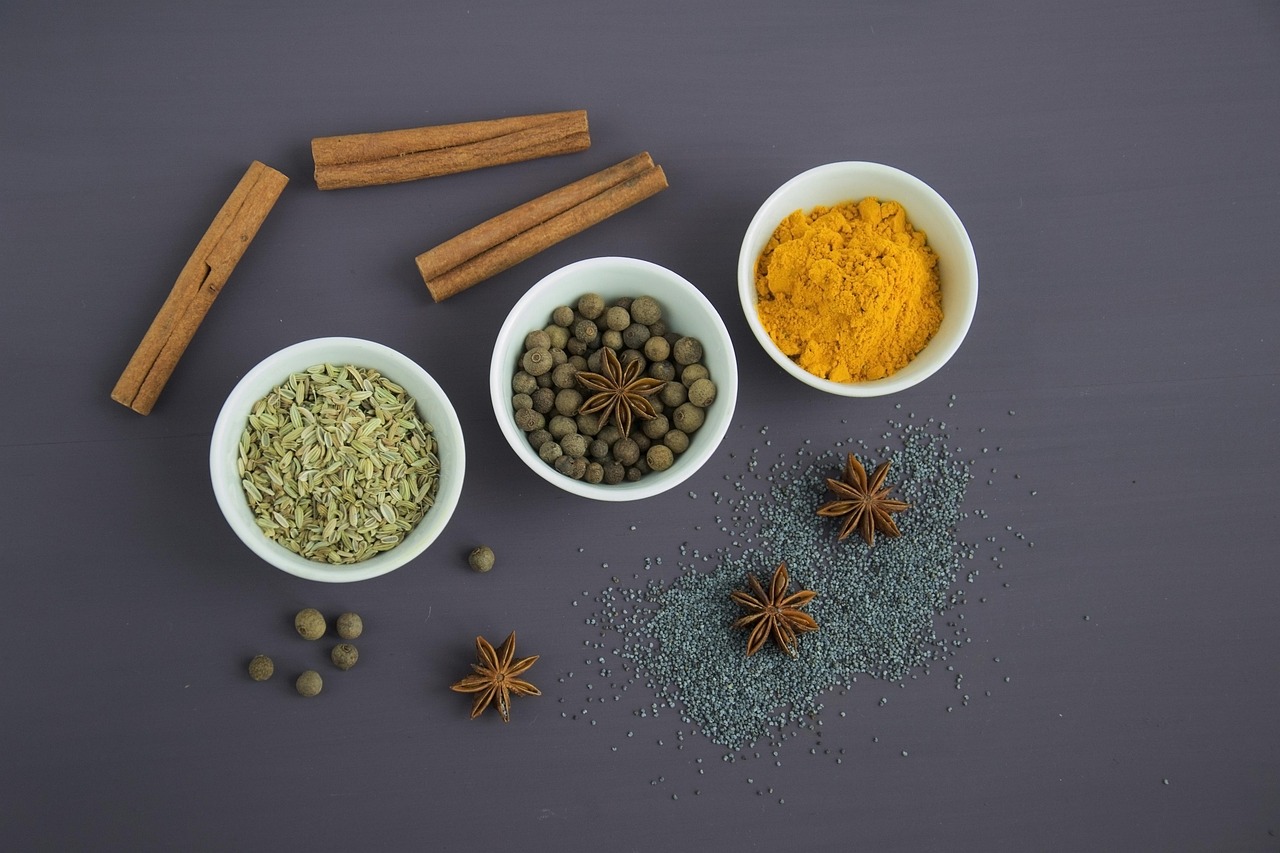 Assorted spices, seeds and cinnamon arranged on a neutral surface
