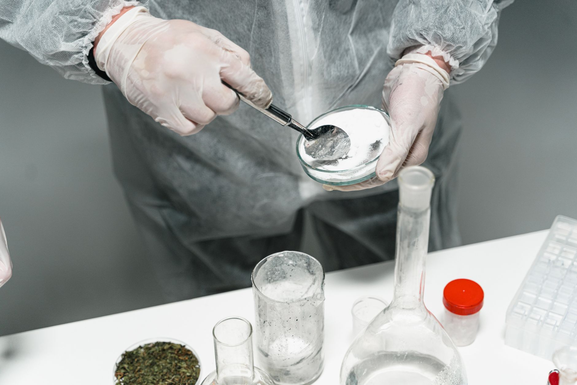 Scientist handling a powder sample during supplement contamination testing
